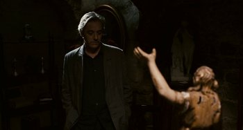 Movie still from “Certified Copy” (2010), directed by Abbas Kiarostami – A man and a woman are standing in a room; Medium shot, Over the shoulder angle