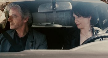 Movie still from “Certified Copy” (2010), directed by Abbas Kiarostami – A man and a woman sitting in the back of a car; Close Up shot, Over the shoulder angle
