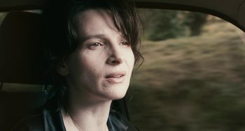 Movie still from “Certified Copy” (2010), directed by Abbas Kiarostami – A person looking out of a car window; Close Up shot, High angle