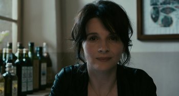 Movie still from “Certified Copy” (2010), directed by Abbas Kiarostami – A person wearing a black jacket; Close Up shot, High angle