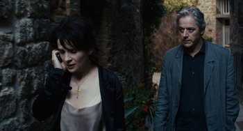 Movie still from “Certified Copy” (2010), directed by Abbas Kiarostami – A man and a woman walking down a street; Medium shot, Over the shoulder angle