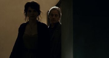 Movie still from “Certified Copy” (2010), directed by Abbas Kiarostami – A man and a woman standing next to each other; Medium shot, Low angle