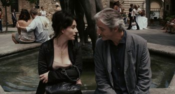 Movie still from “Certified Copy” (2010), directed by Abbas Kiarostami – A man and a woman sitting next to each other; Medium shot, Over the shoulder angle