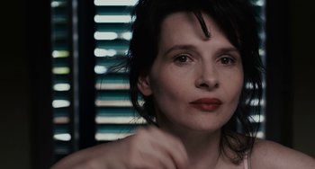 Movie still from “Certified Copy” (2010), directed by Abbas Kiarostami – A person wearing a necklace; Close Up shot, Over the shoulder angle
