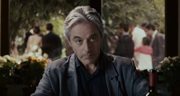 Movie still from “Certified Copy” (2010), directed by Abbas Kiarostami – A person wearing a jacket; Close Up shot, Over the shoulder angle