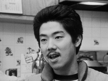 Movie still from “Chan Is Missing” (1982), directed by Wayne Wang – A young man with a beard and a mustache; Close Up shot, Low angle