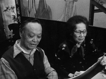 Movie still from “Chan Is Missing” (1982), directed by Wayne Wang – An older man sitting next to an older woman; Medium shot, High angle