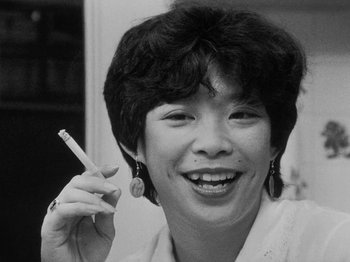 Movie still from “Chan Is Missing” (1982), directed by Wayne Wang – A black - and - white photo of a woman holding a cigarette; Close Up shot, Low angle