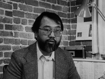 Movie still from “Chan Is Missing” (1982), directed by Wayne Wang – Black and white photograph of a man in a suit and tie; Close Up shot, High angle