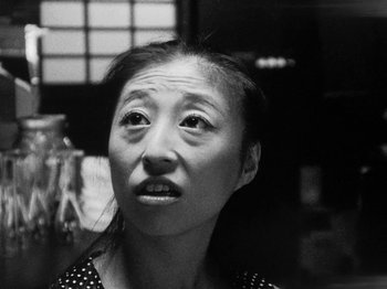 Movie still from “Chan Is Missing” (1982), directed by Wayne Wang – An older woman with a surprised look on her face; Close Up shot, Low angle