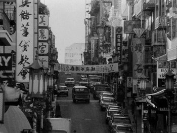 Movie still from “Chan Is Missing” (1982), directed by Wayne Wang – A busy city street filled with lots of traffic; Extreme Wide shot, High angle