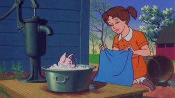 Movie still from “Charlotte's Web” (1973), directed by Iwao Takamoto – A woman holding a blue towel near a tub of water; Medium shot, Low angle