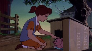 Movie still from “Charlotte's Web” (1973), directed by Iwao Takamoto – A woman kneeling down next to a pig in a cage; Medium shot, High angle
