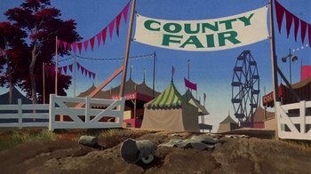 Movie still from “Charlotte's Web” (1973), directed by Iwao Takamoto – An illustration of a county fair with tents and a ferris wheel in the background; Wide shot, Low angle