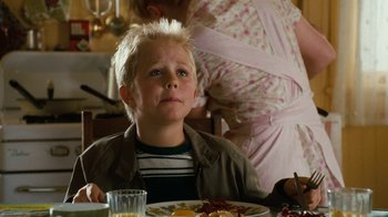 Movie still from “Charlotte's Web” (2006), directed by Gary Winick – A young boy sitting at a table with a plate of food in front of him; Close Up shot, High angle