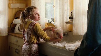 Movie still from “Charlotte's Web” (2006), directed by Gary Winick – A little girl washing a pig in a bath tub; Medium shot, High angle