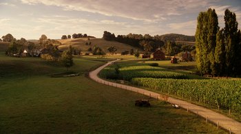 Movie still from “Charlotte's Web” (2006), directed by Gary Winick – An aerial view of a farm with a tractor in the foreground; Extreme Wide shot, High angle