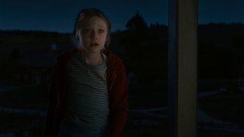 Movie still from “Charlotte's Web” (2006), directed by Gary Winick – A young girl standing in front of a window at night; Medium shot, Over the shoulder angle