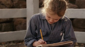 Movie still from “Charlotte's Web” (2006), directed by Gary Winick – A young girl is writing in a notebook; Close Up shot, High angle