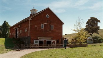 Movie still from “Charlotte's Web” (2006), directed by Gary Winick – A person standing in front of an old red barn; Extreme Wide shot, Low angle