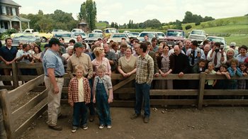 Movie still from “Charlotte's Web” (2006), directed by Gary Winick – A group of people standing in front of a wooden fence; Wide shot, High angle