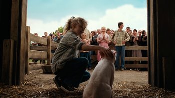 Movie still from “Charlotte's Web” (2006), directed by Gary Winick – A young girl petting a sheep in front of a group of people; Wide shot, Over the shoulder angle
