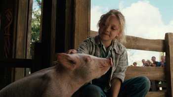 Movie still from “Charlotte's Web” (2006), directed by Gary Winick – A young girl petting a piglet on the nose; Close Up shot, Low angle