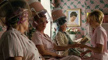 Movie still from “Charlotte's Web” (2006), directed by Gary Winick – A group of women sitting down with their hair dryers on their heads; Medium shot, Over the shoulder angle