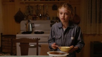 Movie still from “Charlotte's Web” (2006), directed by Gary Winick – A young girl holding a bowl of food in a kitchen; Medium shot, Over the shoulder angle