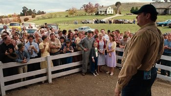 Movie still from “Charlotte's Web” (2006), directed by Gary Winick – A group of people standing in front of a white fence; Wide shot, Over the shoulder angle