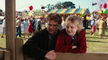 Movie still from “Charlotte's Web” (2006), directed by Gary Winick – A man and a girl sitting next to each other at an event; Medium shot, Over the shoulder angle