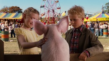 Movie still from “Charlotte's Web” (2006), directed by Gary Winick – Two children petting a pig at an amusement park; Medium shot, Over the shoulder angle