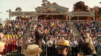 Movie still from “Charlotte's Web” (2006), directed by Gary Winick – A man juggling balls in front of a crowd of people; Wide shot, Over the shoulder angle