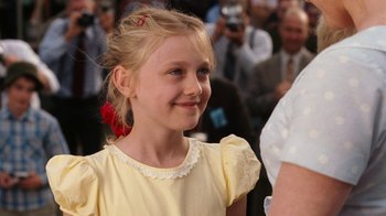 Movie still from “Charlotte's Web” (2006), directed by Gary Winick – A young girl in a yellow dress smiling for the camera; Close Up shot, Over the shoulder angle
