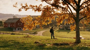 Movie still from “Charlotte's Web” (2006), directed by Gary Winick – A man standing in a field with a leaf blower; Extreme Wide shot, Over the shoulder angle