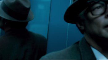 Movie still from “Che: Part Two” (2008), directed by Steven Soderbergh – Two men in hats are standing in front of a mirror; Close Up shot, Over the shoulder angle