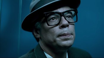 Movie still from “Che: Part Two” (2008), directed by Steven Soderbergh – A person wearing glasses and a hat; Close Up shot, Low angle