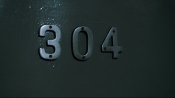 Movie still from “Che: Part Two” (2008), directed by Steven Soderbergh – The numbers 3 0 4 on a wall; Extreme Close Up shot, High angle