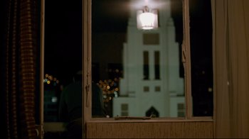 Movie still from “Che: Part Two” (2008), directed by Steven Soderbergh – A view through a window of a church at night; Extreme Wide shot, Low angle