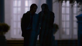 Movie still from “Che: Part Two” (2008), directed by Steven Soderbergh – Two men standing next to each other in front of a window; Medium shot, Over the shoulder angle