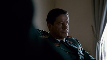 Movie still from “Che: Part Two” (2008), directed by Steven Soderbergh – A person wearing a military uniform; Close Up shot, Over the shoulder angle