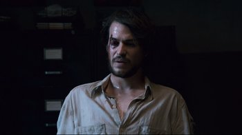 Movie still from “Che: Part Two” (2008), directed by Steven Soderbergh – A person wearing a shirt; Close Up shot, Over the shoulder angle