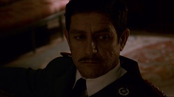 Movie still from “Che: Part Two” (2008), directed by Steven Soderbergh – A person wearing a uniform; Close Up shot, Low angle