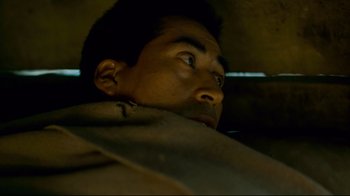 Movie still from “Che: Part Two” (2008), directed by Steven Soderbergh – A man's face in a car; Close Up shot, Low angle