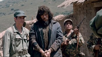 Movie still from “Che: Part Two” (2008), directed by Steven Soderbergh – A group of men standing next to each other; Medium shot, Low angle