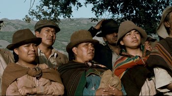 Movie still from “Che: Part Two” (2008), directed by Steven Soderbergh – A group of men wearing hats and standing next to each other; Medium shot, Low angle