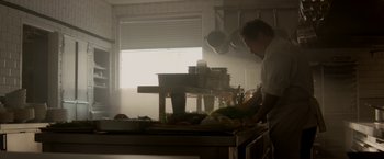 Movie still from “Chef” (2014), directed by Jon Favreau – A man standing in front of a counter in a kitchen; Medium shot, Low angle