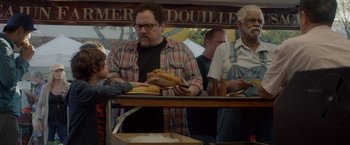 Movie still from “Chef” (2014), directed by Jon Favreau – A group of people standing around a table with sandwiches on it; Medium shot, Over the shoulder angle