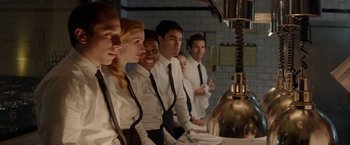 Movie still from “Chef” (2014), directed by Jon Favreau – A group of people standing in front of a counter; Medium shot, Low angle