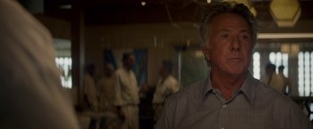 Movie still from “Chef” (2014), directed by Jon Favreau – A group of people in a room with a man in a dress shirt; Close Up shot, Over the shoulder angle